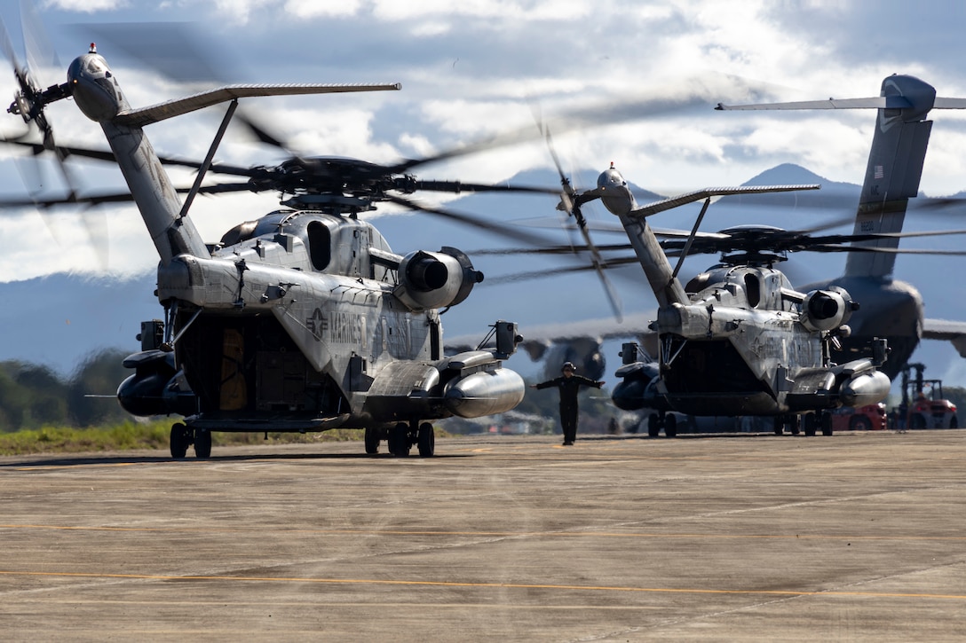 U.S. Marine Corps CH-53E Super Stallions attached to Marine Medium Tiltrotor Squadron (VMM) 163 (Reinforced), Marine Aircraft Group 16, 3rd Marine Aircraft Wing, taxi on the runway at Antonio Bautista Air Base as part of Marine Aviation Support Activity (MASA) 23 events in Puerto Princesa, Palawan, Philippines, July 6, 2023. MASA is a bilateral exercise between the Armed Forces of the Philippines and the U.S. Marine Corps, aimed at enhancing interoperability and coordination focused on aviation-related capabilities. During MASA 23, Filipino and U.S. Marines conduct approximately twenty different training evolutions, including live-fire, air assaults, and subject matter expert exchanges across aviation, ground, and logistics capabilities. (U.S. Marine Corps photo by Cpl. Sean A. Potter)