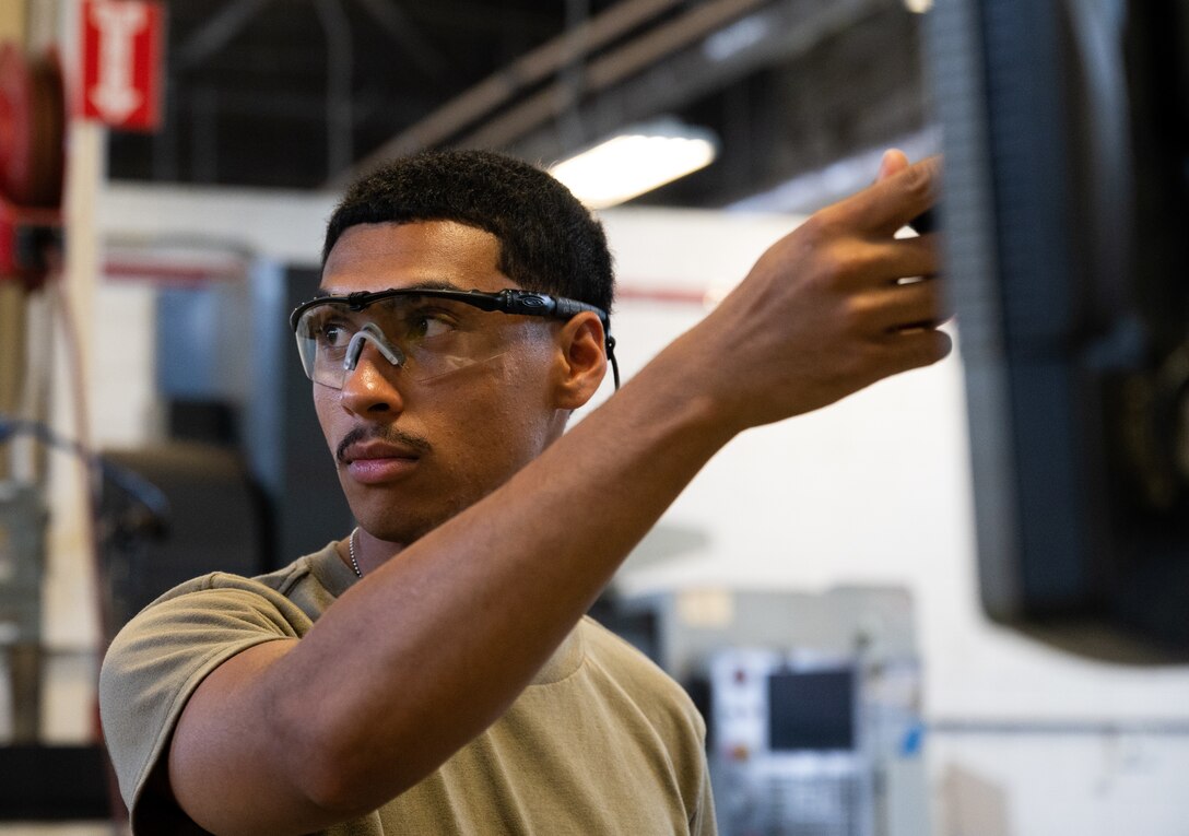 Metal Techs use a mill to repair F-22 machinery at JBLE