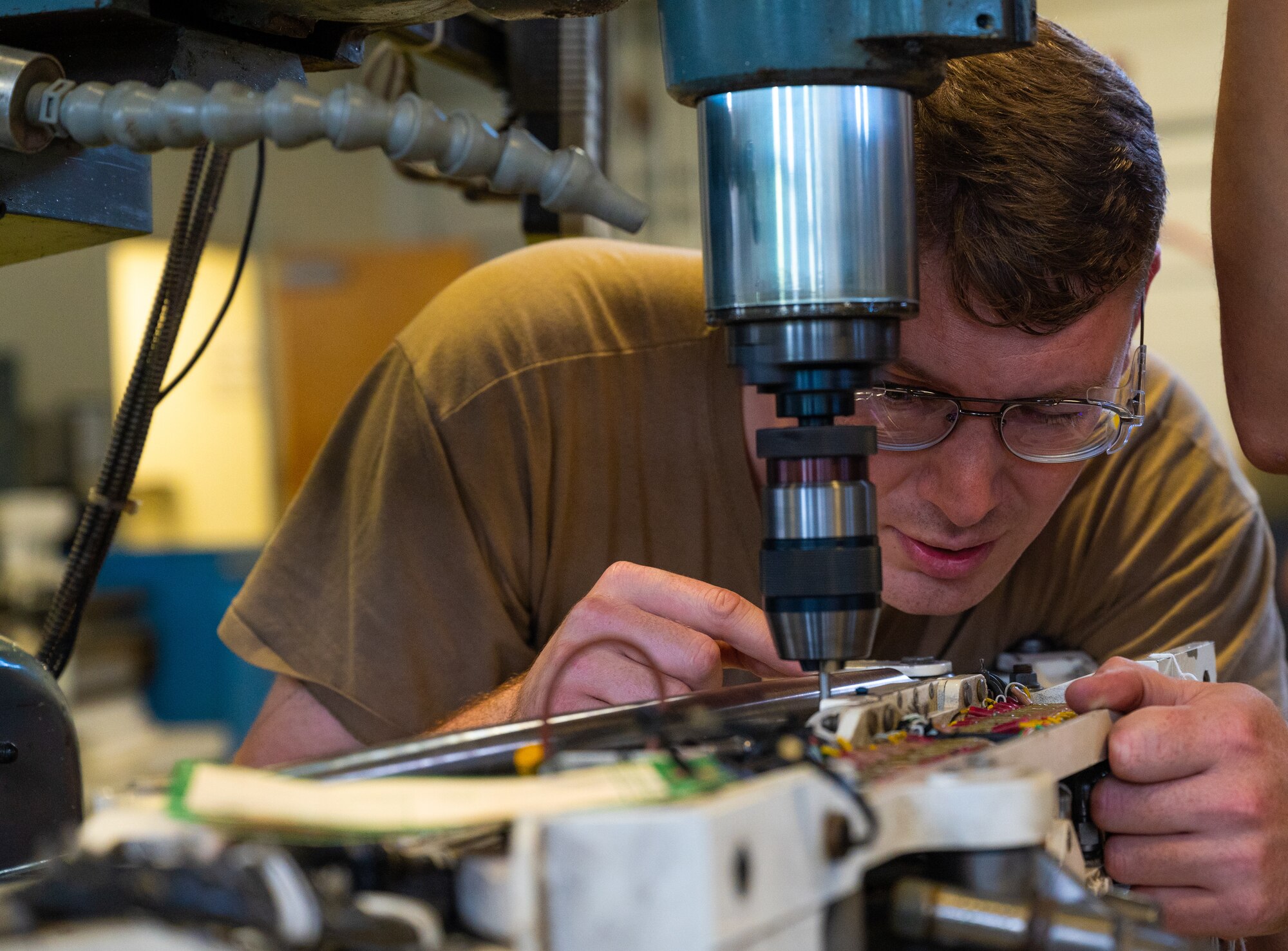 Metal Techs use a mill to repair F-22 machinery at JBLE