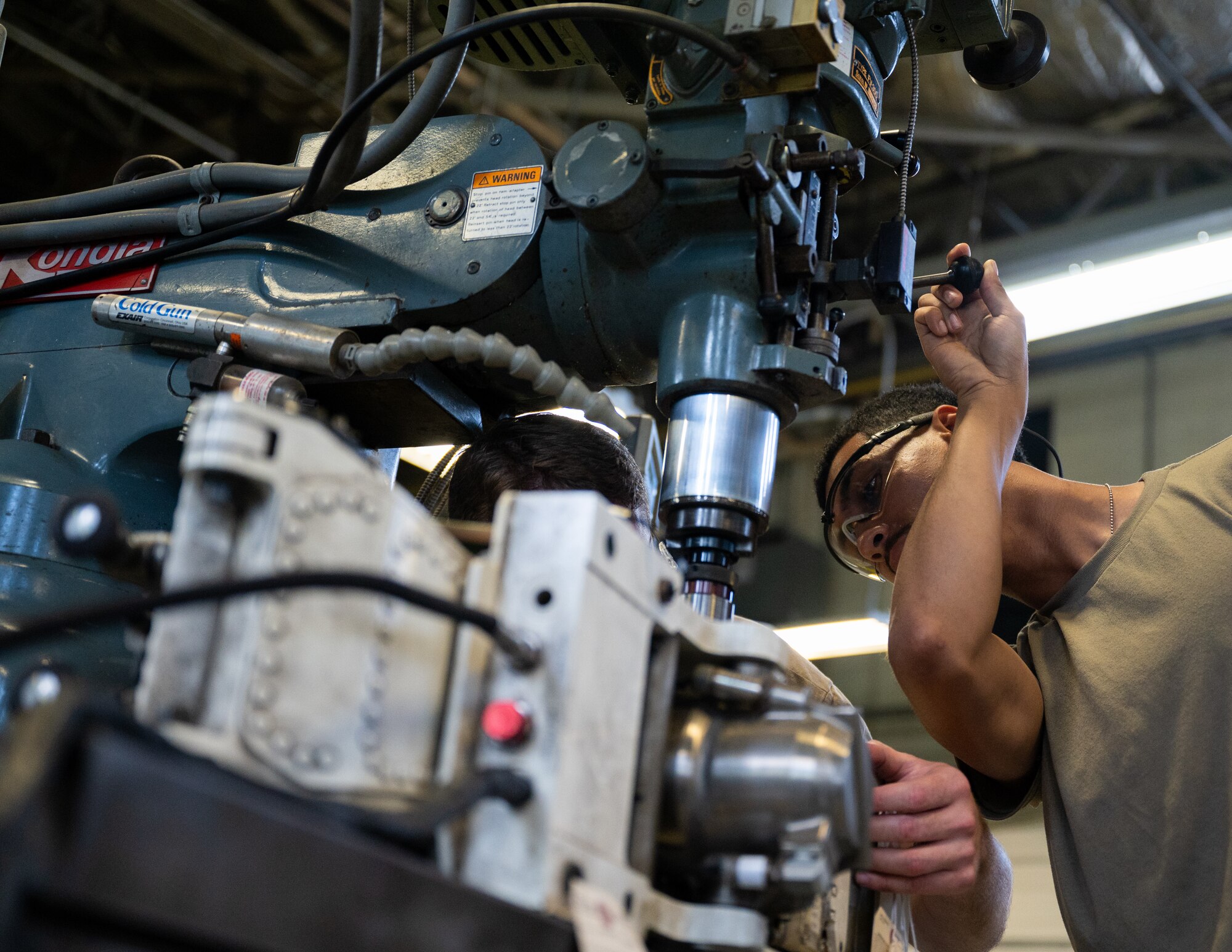 Metal Techs use a mill to repair F-22 machinery at JBLE