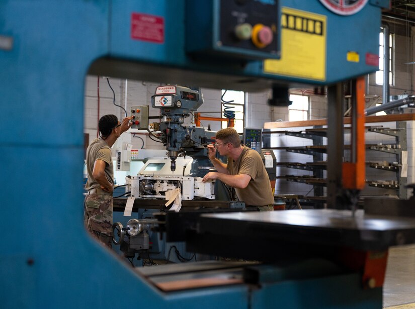 Metal Techs use a mill to repair F-22 machinery at JBLE
