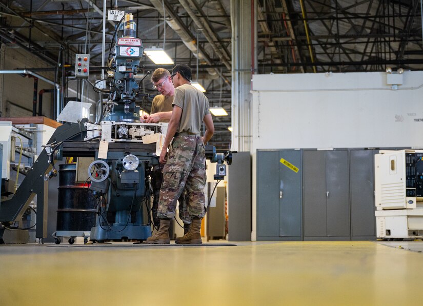 Metal Techs use a mill to repair F-22 machinery at JBLE