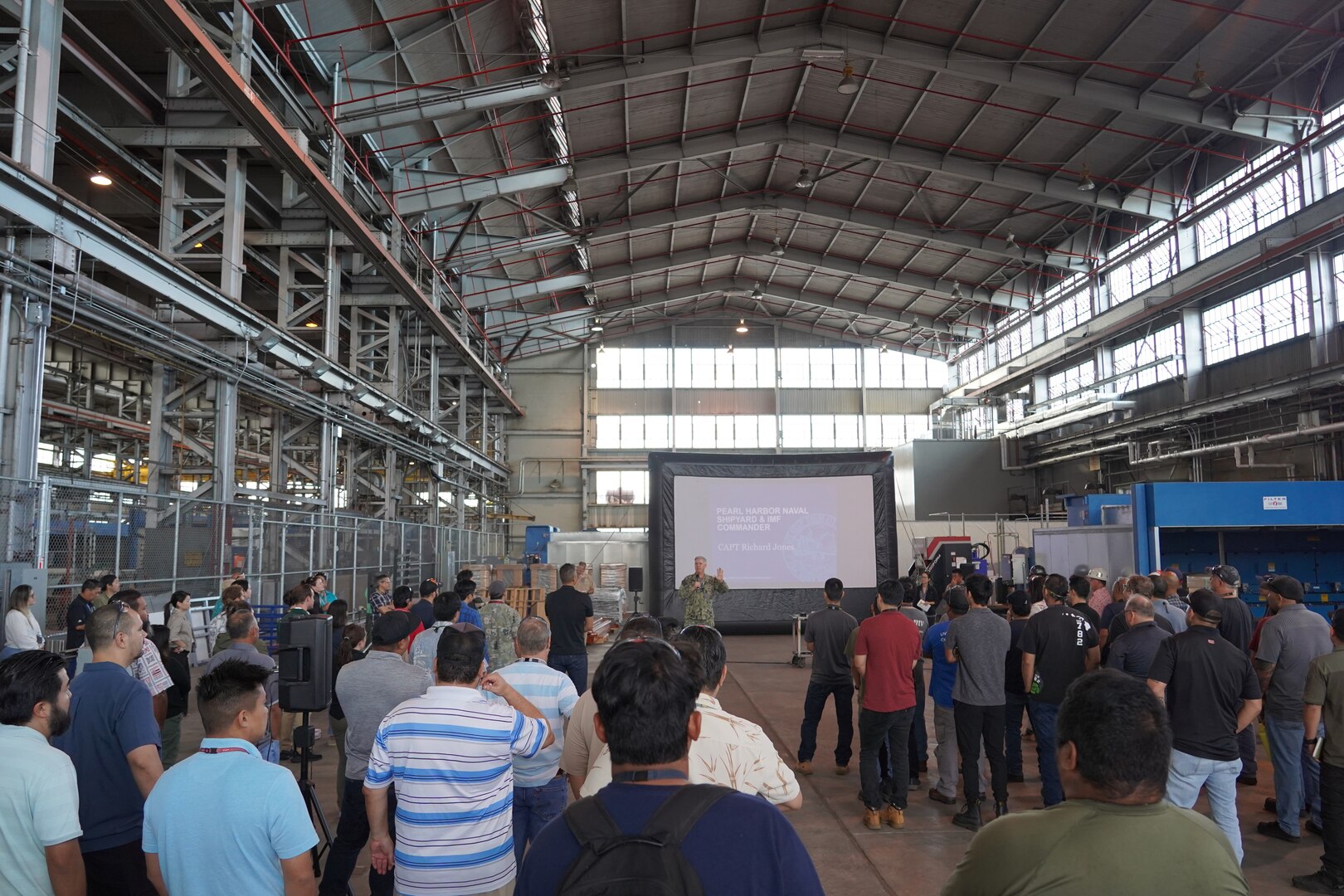 Pearl Harbor Naval Shipyard Commander Capt. Richard Jones, center, briefs shipyard personnel during a Town Hall held at the Structural Shop at Pearl Harbor Naval Shipyard.