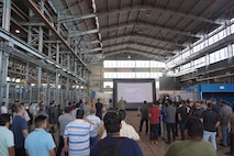 Pearl Harbor Naval Shipyard Commander Capt. Richard Jones, center, briefs shipyard personnel during a Town Hall held at the Structural Shop at Pearl Harbor Naval Shipyard.