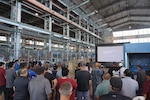 Pearl Harbor Naval Shipyard Commander Capt. Richard Jones, center, briefs shipyard personnel during a Town Hall held at the Structural Shop at Pearl Harbor Naval Shipyard.