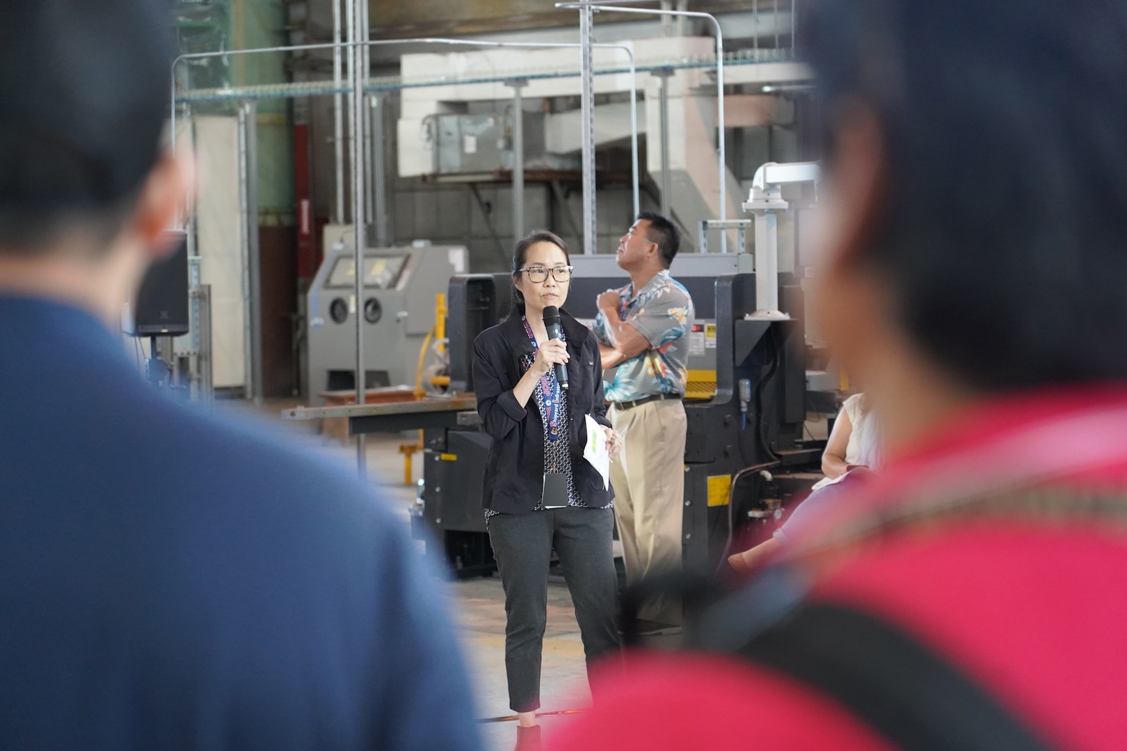 Shipyard Infrastructure Optimization Program Department Director Joanna Victorino, center, briefs shipyard personnel during a Town Hall held at the Structural Shop at Pearl Harbor Naval Shipyard.