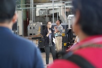 Shipyard Infrastructure Optimization Program Department Director Joanna Victorino, center, briefs shipyard personnel during a Town Hall held at the Structural Shop at Pearl Harbor Naval Shipyard.