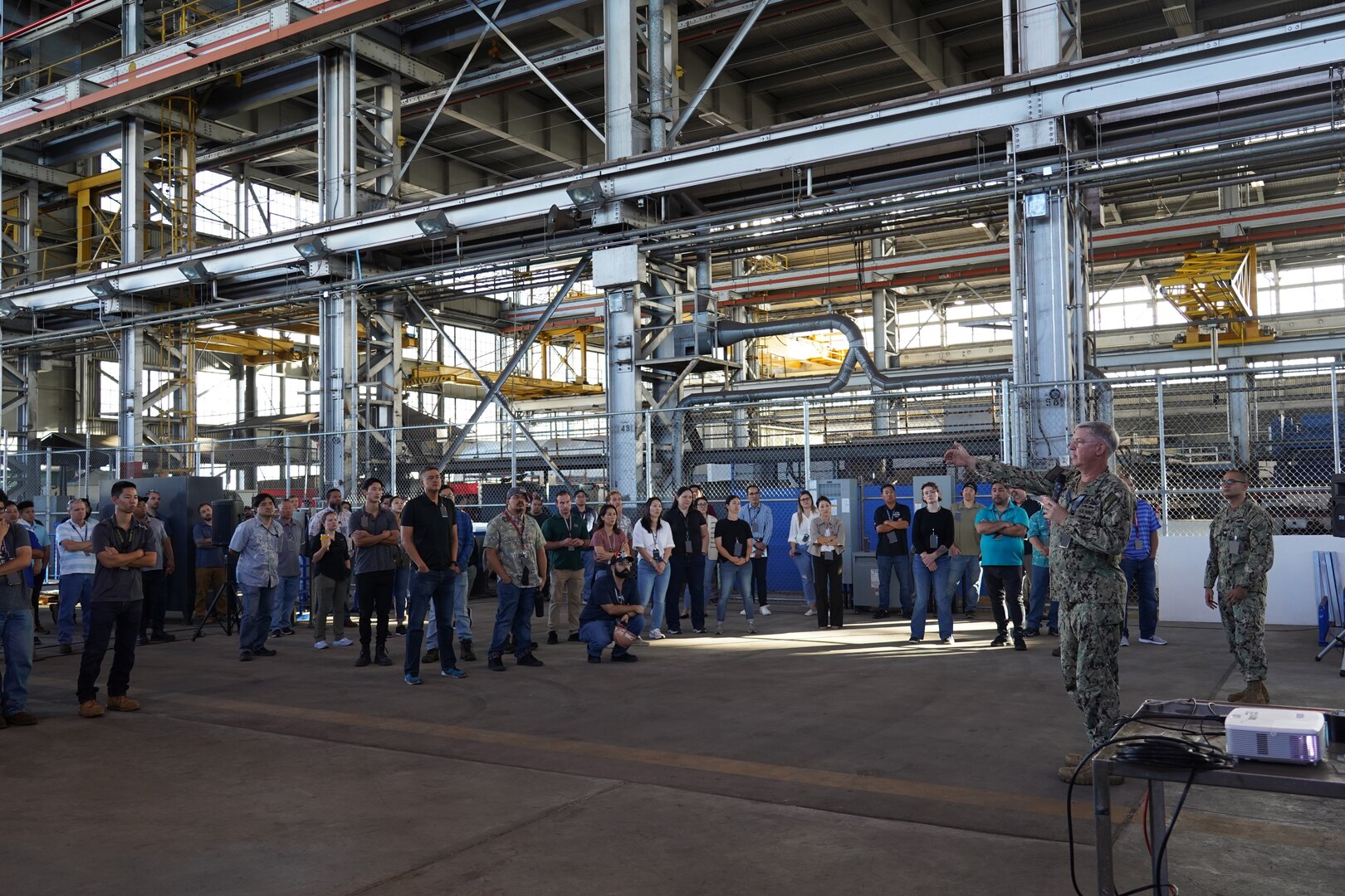 Pearl Harbor Naval Shipyard Commander Capt. Richard Jones, right, briefs shipyard personnel during a Town Hall held at the Structural Shop at Pearl Harbor Naval Shipyard.