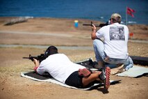 Bob Smith, (right) an instructor with the Anti-terrorism Center on Ford Island and Kaneohe resident, shoots with his son during a recreational fire event at the Kaneohe Bay Range Training Facility, Aug. 9.