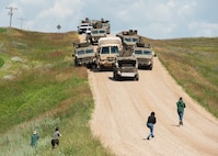 Defenders, from the 91st Security Forces Group, simulate an assault on a convoy in Mountrail County, North Dakota, July 7, 2023. Recapture and recovery exercises integrate convoy operations to enhance security and force preparation. (U.S. Air Force photo by Airman 1st Class Kyle Wilson)