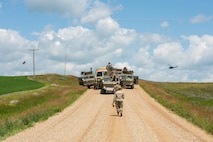 Defenders, assigned to the 91st Security Forces Group, regroup at their convoy in Mountrail County, North Dakota, July 7, 2023. The defenders encountered and eliminated an opposing force during a recapture and recovery exercise to validate their readiness in convoy operations. (U.S. Air Force photo by Airman 1st Class Kyle Wilson)