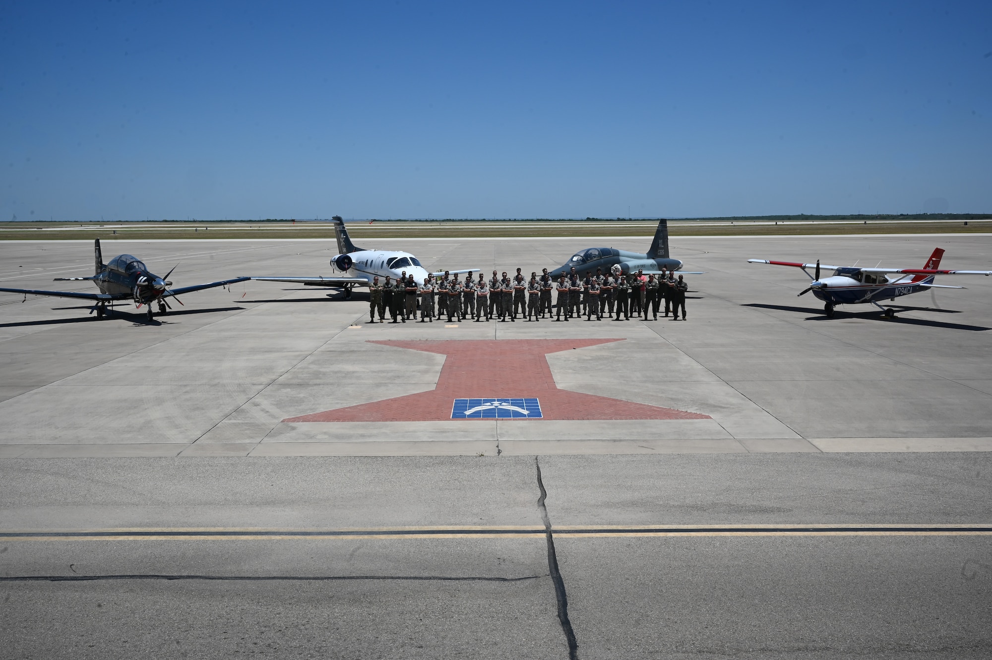 Civil Air Patrol cadets, cadre, and Team XL personnel pose for a group photo on the flightline at Laughlin Air Force Base, Texas, June 27, 2023.