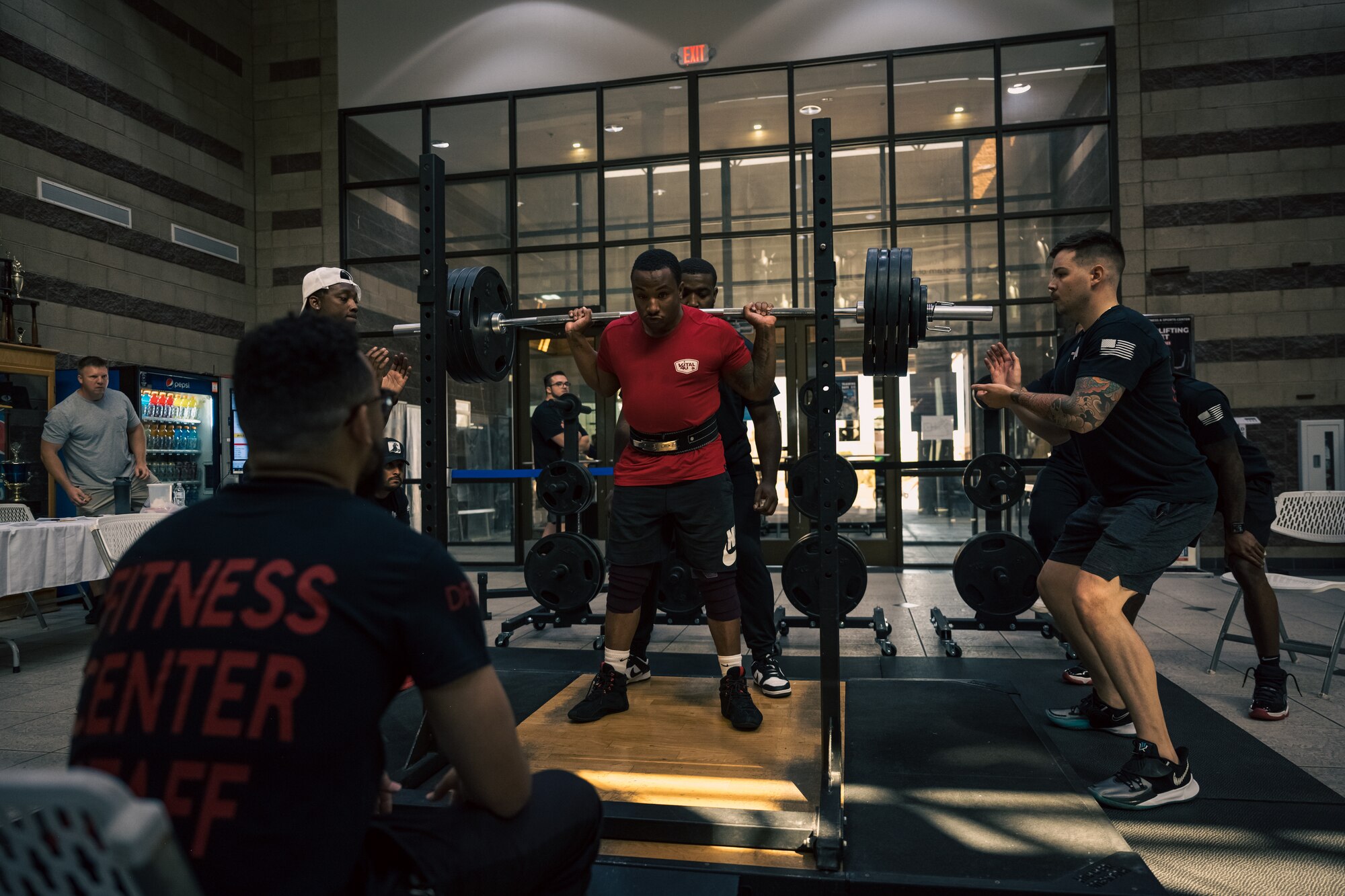 U.S. Air Force Airman 1st Class Devin Robinson, 49th Security Forces Squadron entry controller, performs a back squat during a weightlifting meet at Holloman Air Force Base, New Mexico, July 8, 2023. The event consisted of various weightlifting exercises to improve morale and comradery while raising esprit de corps through healthy competition between Airmen and civilians. (U.S. Air Force photo by Senior Airman Antonio Salfran)