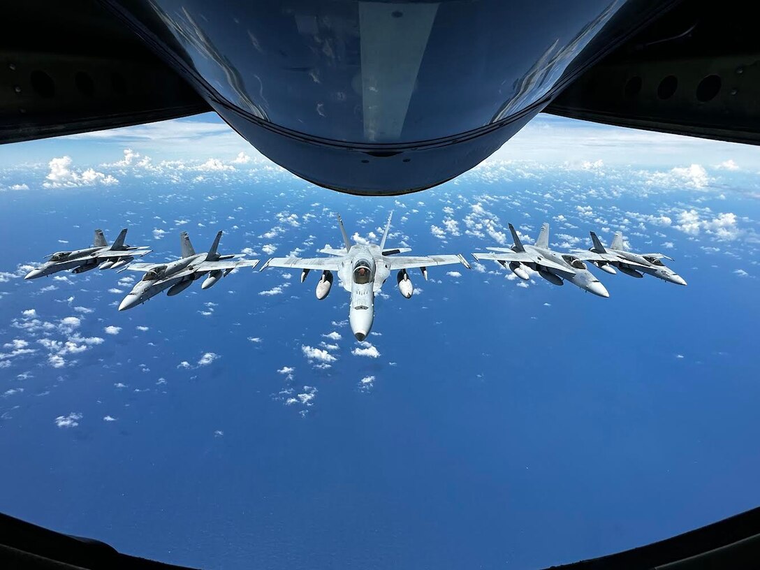 U.S. Marine Corps F/A-18 Hornets assigned to Marine Fighter Attack Squadron (VMFA) 323, Marine Aircraft Group 11, 3rd Marine Aircraft Wing, fly in formation during a trans-Pacific flight en route to Marine Aviation Support Activity (MASA) 23, at sea, July 8, 2023. MASA is a bilateral exercise between the Armed Forces of Philippines and the U.S. Marine Corps, aimed at enhancing interoperability and coordination focused on aviation-related capabilities.
