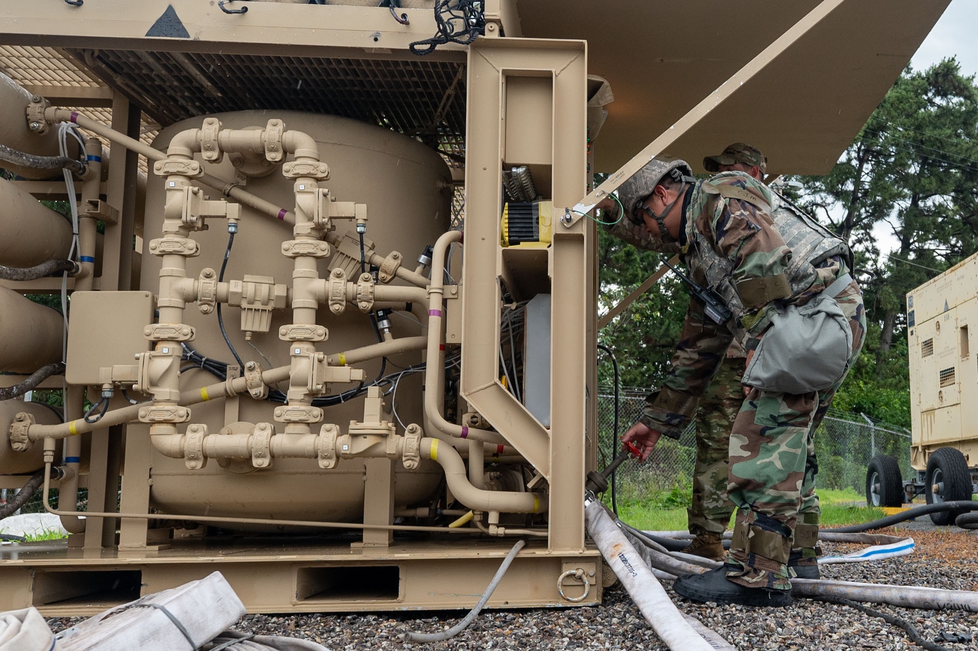 Two 8th CES Airmen initiate the reserve osmosis water purification unit’s water intake sequence during the training