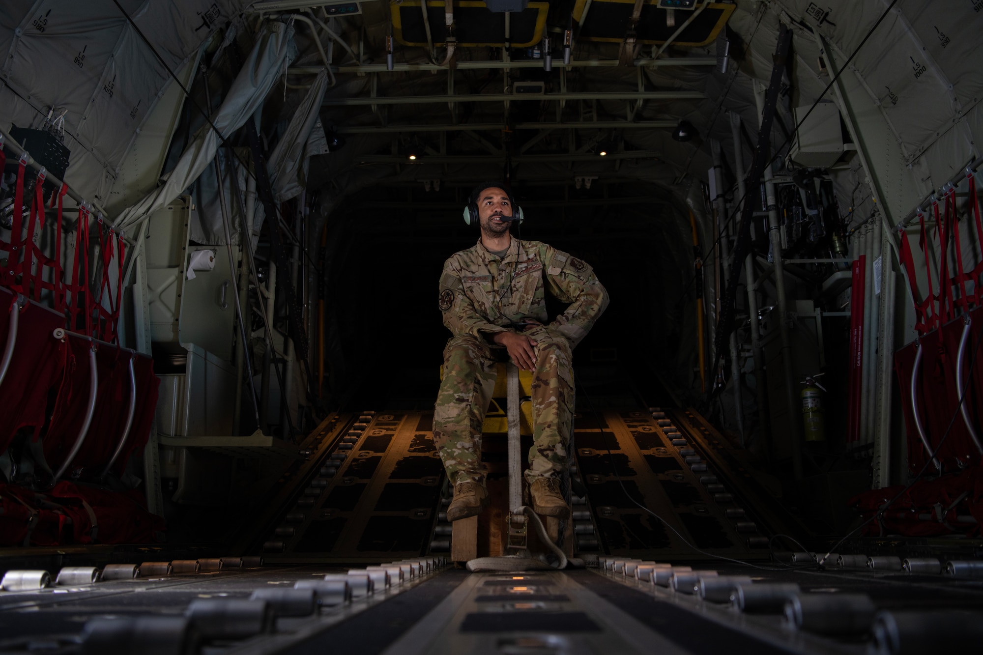 Aircraft loadmaster communicating with pilots via coms