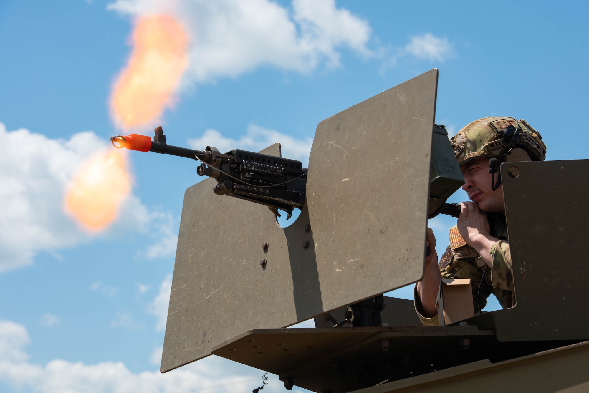 Airman 1st Class Troy White, 891st Missile Security Forces Squadron defender, fires blanks from an M240B machine gun from a Humvee turret in Mountrail County, North Dakota, July 7, 2023. The Humvee is a tactical, high-mobility vehicle that offers protection to defenders while engaging threats. (U.S. Air Force photo by Airman 1st Class Kyle Wilson)