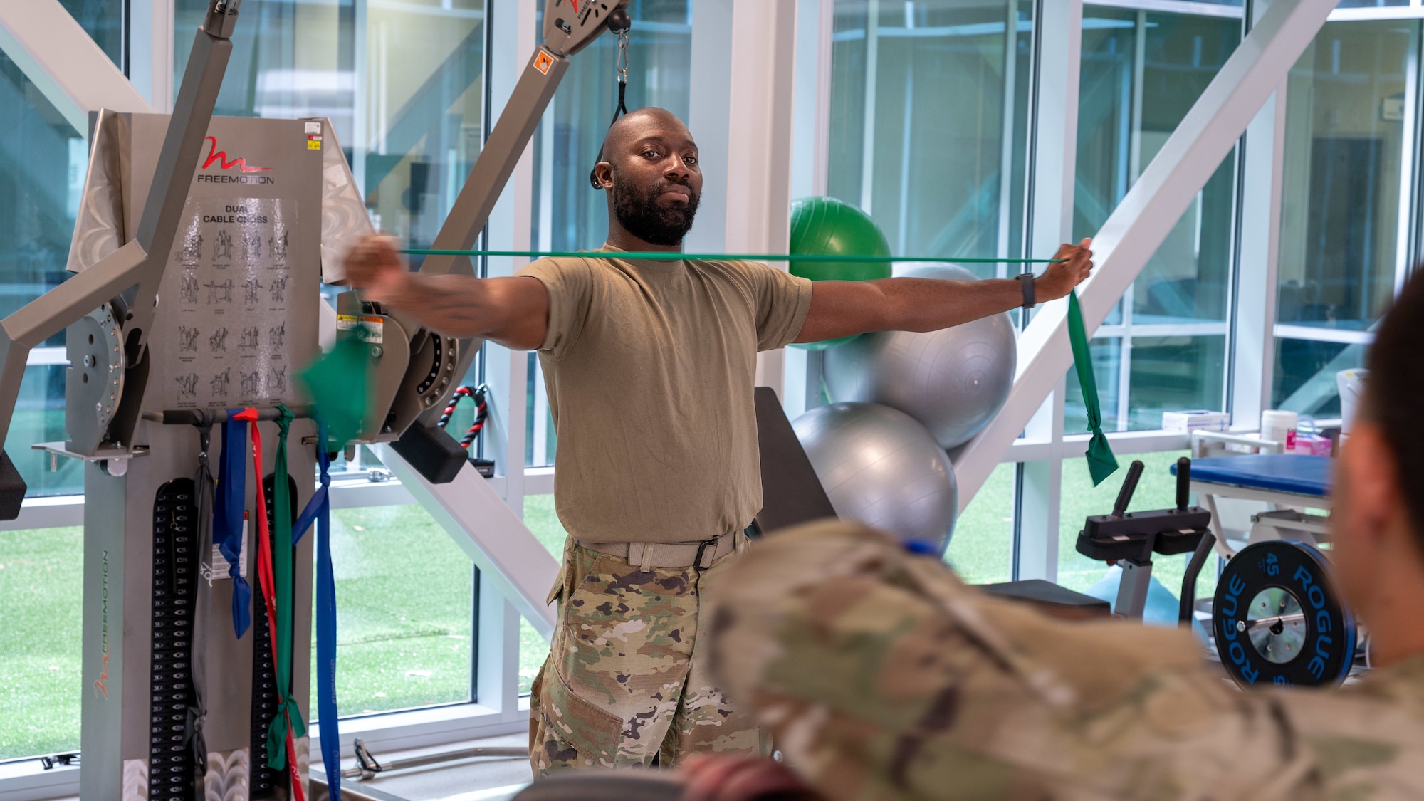 Tech. Sgt. Jarvis James, 567th Red Horse Squadron unit training manager, exercises using a band at Seymour Johnson Air Force Base, North Carolina, June 22, 2023. The physical therapy clinic’s vision is to maintain professional Airmen ready to fight, and one of the wing commander’s priorities is to improve combat readiness. (U.S. Air Force photo by Airman 1st Class Leighton Lucero)