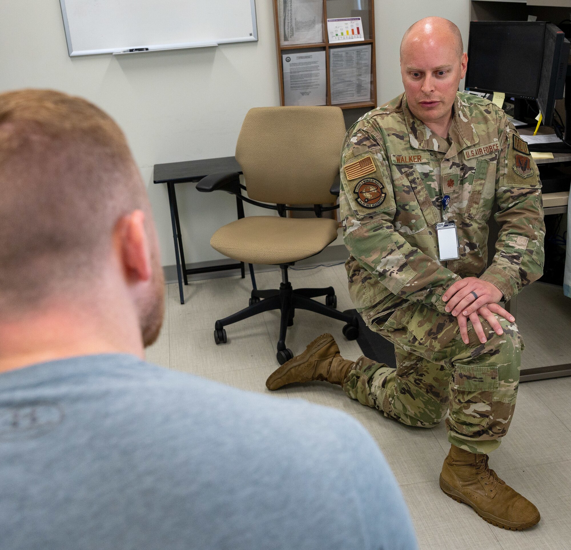 Maj. Jeffrey Walker, right, 4th Operational Medical Readiness Squadron human performance flight commander, shows Staff Sgt. Trevor Herrli, 333rd Fighter Generation Squadron weapons load team chief, a stretch to assist in rehabilitating his injury at Seymour Johnson Air Force Base, North Carolina, June 22, 2023. Physical therapy is a resource that adds to the 4th Fighter Wing’s mission, to maintain combat airpower. (U.S. Air Force photo by Airman 1st Class Leighton Lucero) (This photo was adjusted for security reasons)
