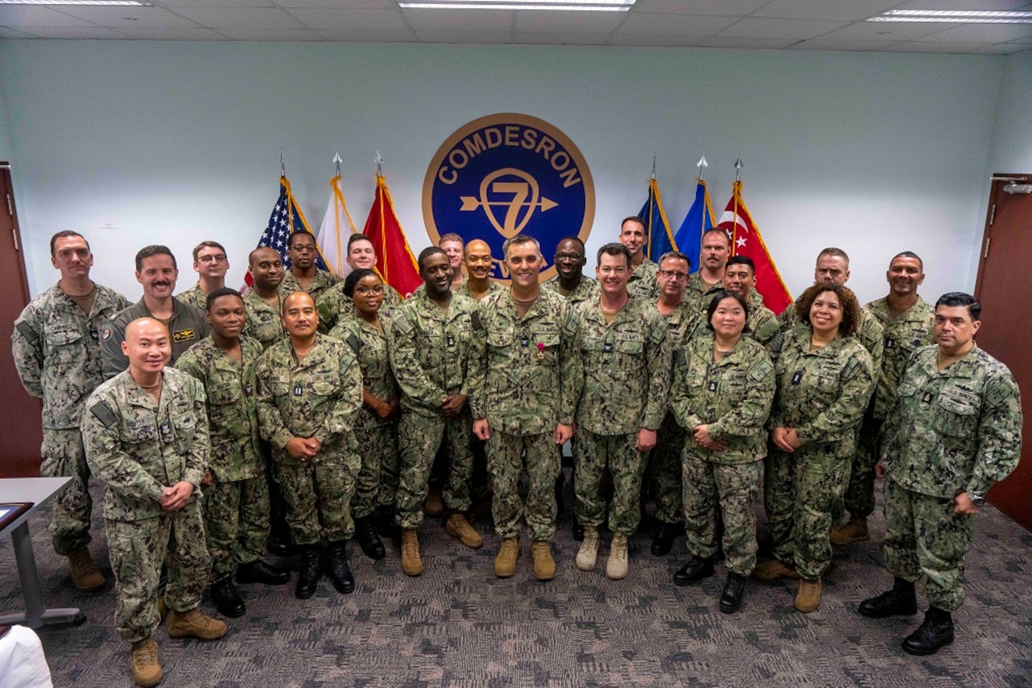 SINGAPORE (July 7, 2023) Destroyer Squadron (DESRON) 7 Sailors pose for a group photograph following a change of command ceremony at Changi Naval Base in Singapore, July 7. As the U.S. Navy’s destroyer squadron forward-deployed in Southeast Asia, DESRON 7 serves as the primary tactical and operational commander of littoral combat ships rotationally deployed to Singapore, Expeditionary Strike Group (ESG) 7’s Sea Combat Commander and builds partnerships through training exercises and military-to-military engagements. (U.S. Navy photo by Mass Communications Specialist 1st Class Brandon Parker)