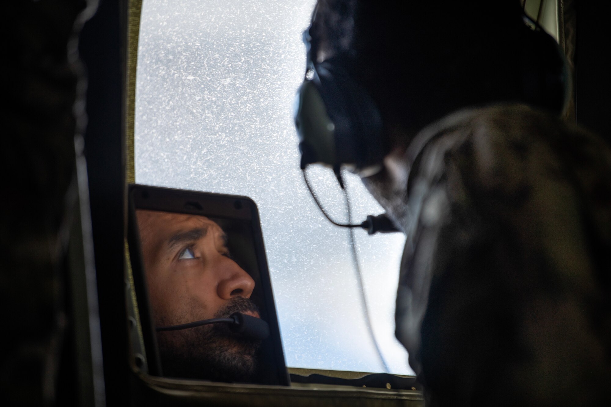 Airman observing C-130J engines during flight