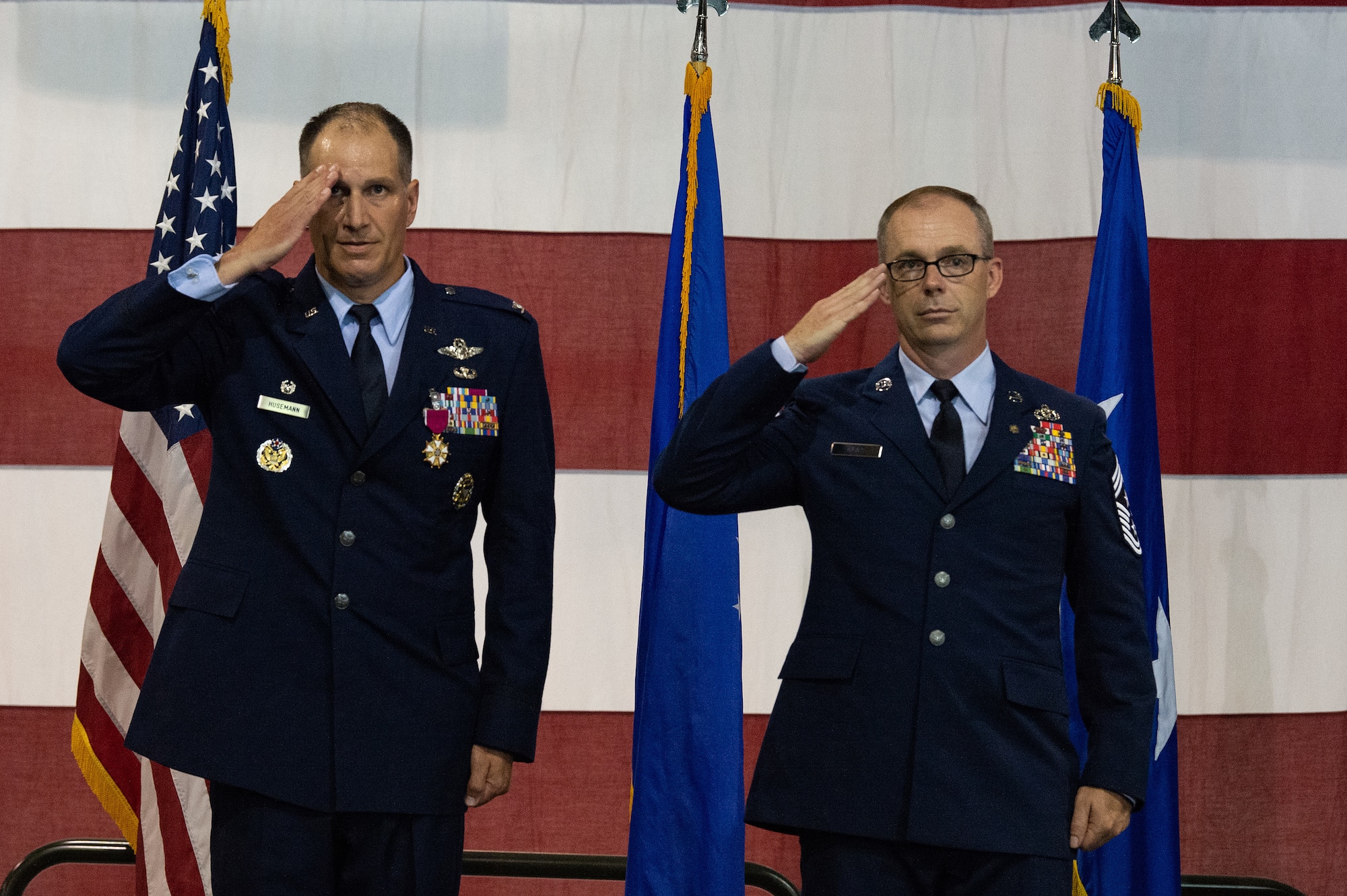 Col. Matthew S. Husemann, left, 436th Airlift Wing commander, and retired Chief Master Sgt. Timothy M. Bayes, right, former 436th AW command chief, give their final salute to a formation of Team Dover Airmen during the 436th AW Change of Command ceremony on Dover Air Force Base, Delaware, July 7, 2023. Husemann relinquished command to Col. William C. McDonald, who became the wing’s 37th commander. (U.S. Air Force photo by Roland Balik)
