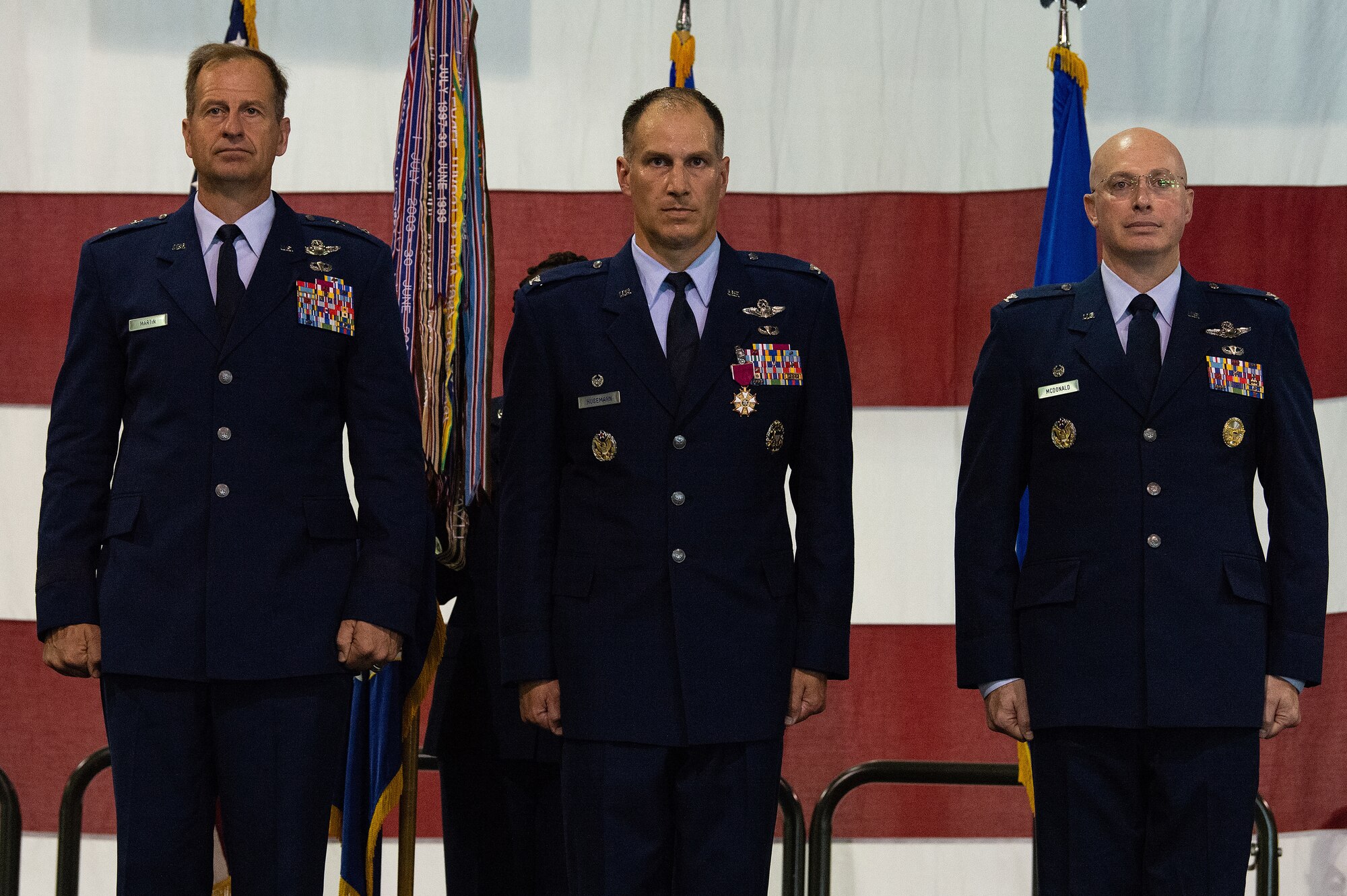 From left, Maj. Gen. Corey J. Martin, 18th Air Force commander, Col. Matthew S. Husemann, outgoing 436th Airlift Wing commander, and Col. William C. McDonald, incoming 436th AW commander, stand at attention during the 436th AW Change of Command ceremony at Dover Air Force Base, Delaware, July 7, 2023. Husemann relinquished command to McDonald in a ceremony attended by family, friends, distinguished visitors, local civic leaders and members of Team Dover. (U.S. Air Force photo by Roland Balik)
