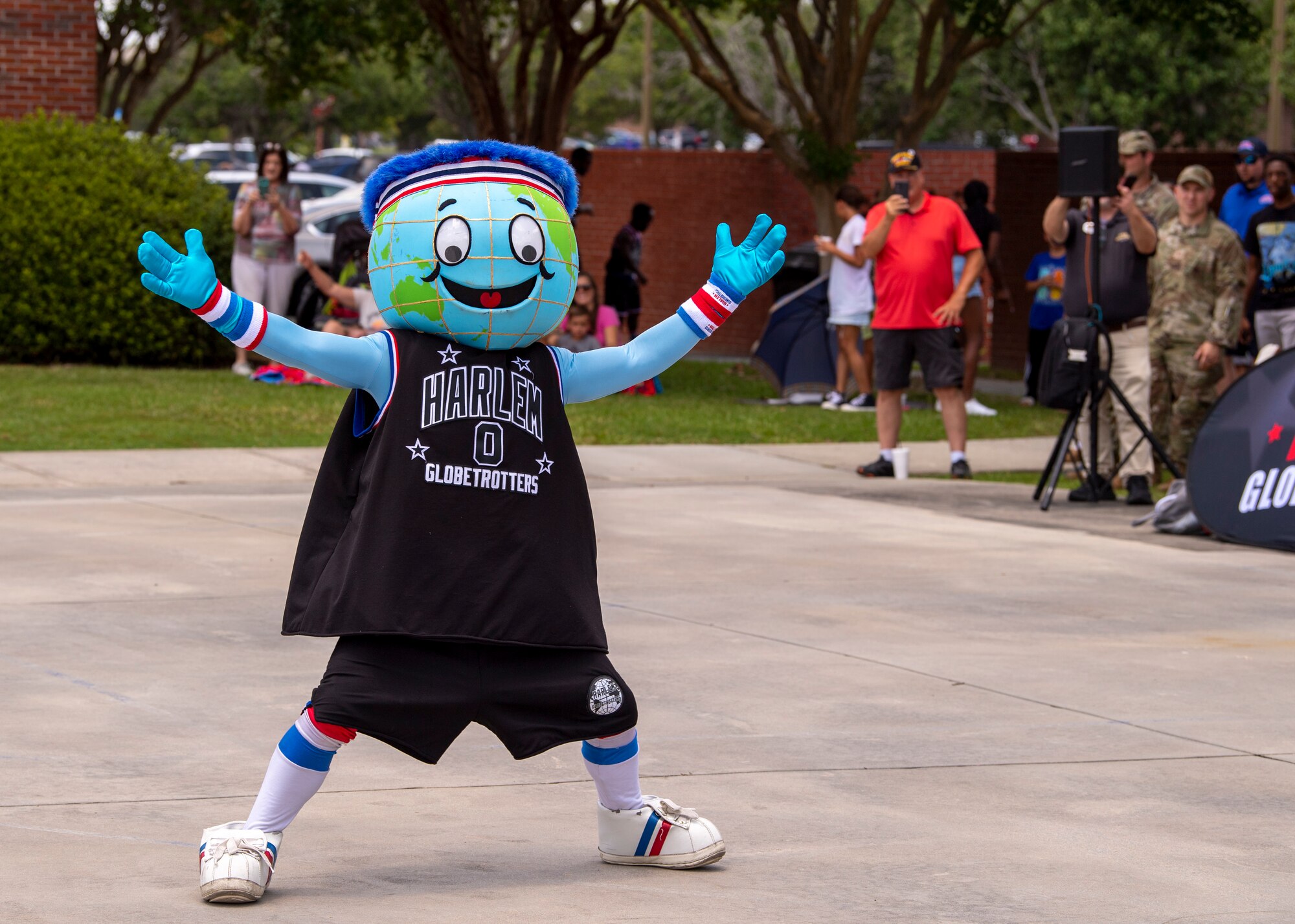 Harlem Globetrotters’ mascot, Globie, welcomes the crowd during a visit to Moody Air Force Base, Georgia, July 6, 2023. Globie is the most traveled professional sports mascot in the world. (U.S. Air Force photo by Airman 1st Class Leonid Soubbotine)