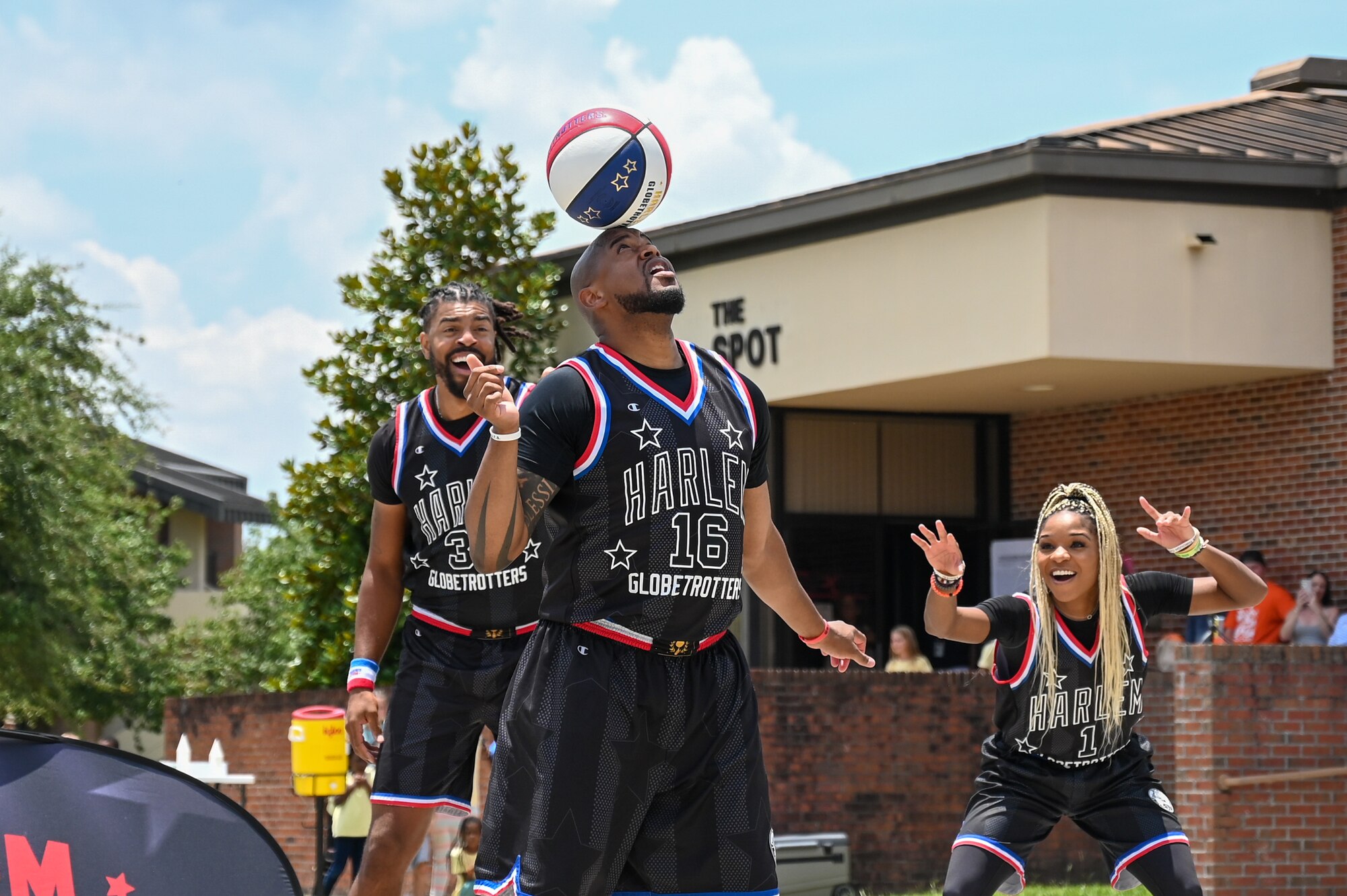 Harlem Globetrotter Shane “Scooter” Christensen spins a basketball on his head during the teams visit to Moody Air Force Base, Georgia July 6, 2023. The team is famous for their ball-handling skills, trick shots, dunks and unique world records. (U.S. Air Force photo by Senior Airman Stacey Thornburg)