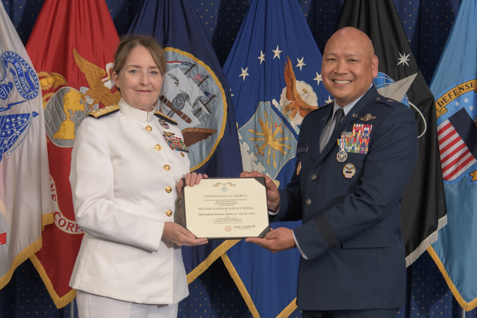 Two military general officers hold a certificate