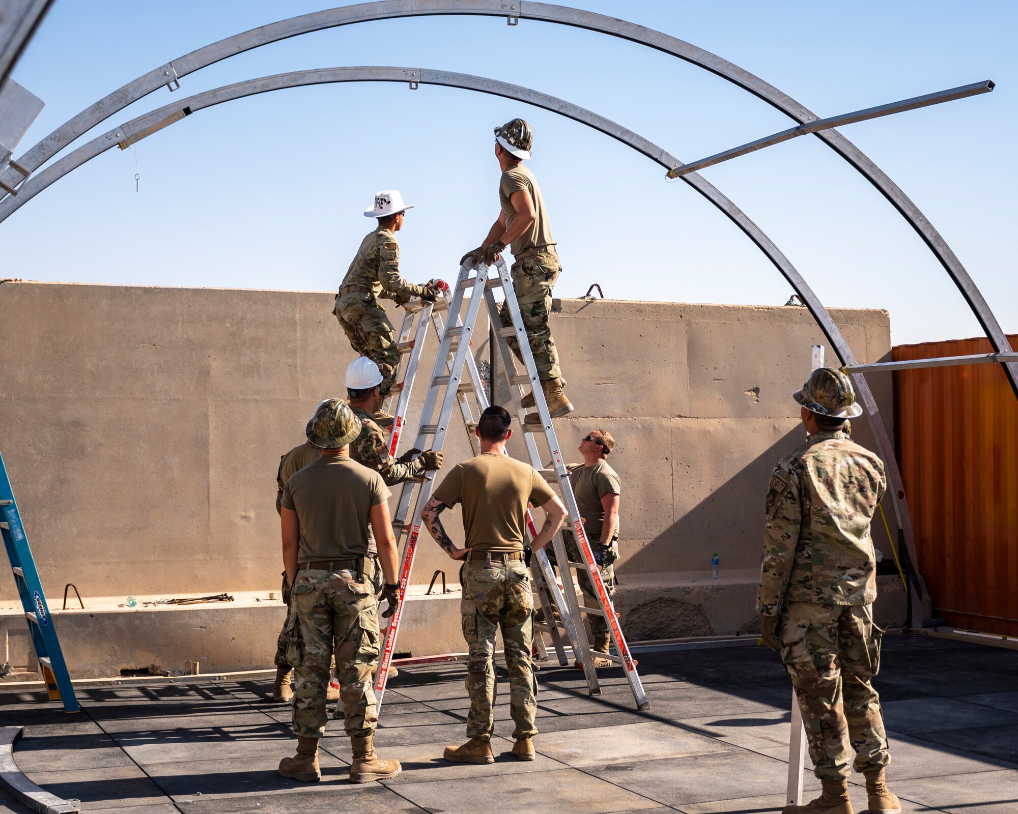 U.S. Air Force service members from the 386th Expeditionary Civil Engineer Squadron Dirt Boyz, receive training on the construction of a medium-sized shelter (MSS) at Ali Al Salem Air Base, Kuwait, July 6, 2023.