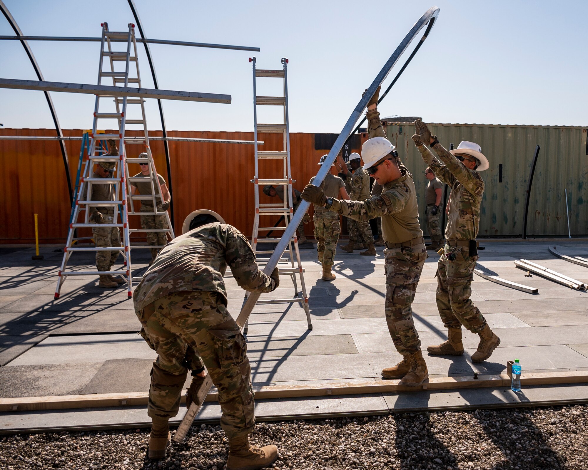 U.S. Air Force service members from the 386th Expeditionary Civil Engineer Squadron Dirt Boyz, receive training on the construction of a medium-sized shelter (MSS) at Ali Al Salem Air Base, Kuwait, July 6, 2023.