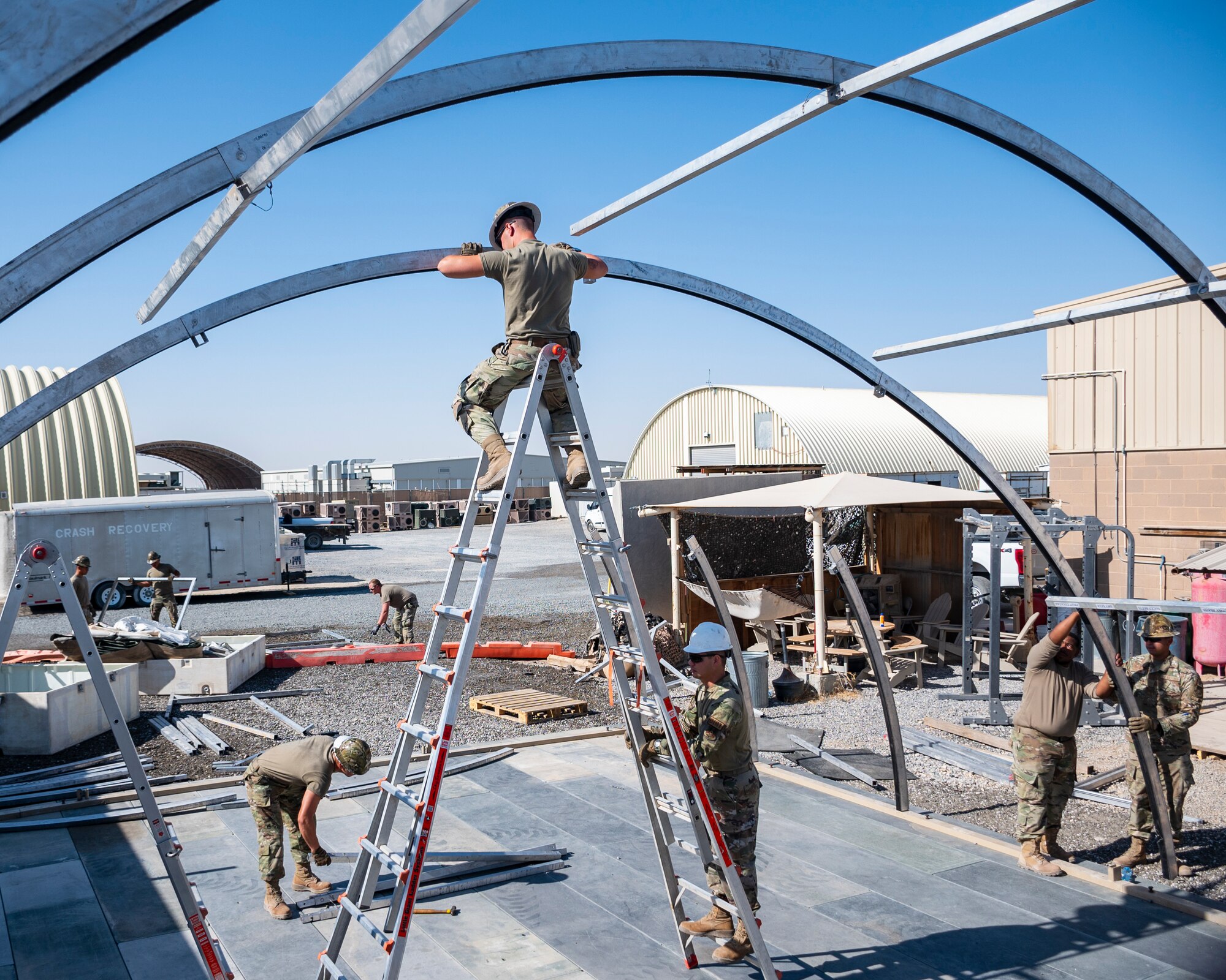 U.S. Air Force service members from the 386th Expeditionary Civil Engineer Squadron Dirt Boyz, receive training on the construction of a medium-sized shelter (MSS) at Ali Al Salem Air Base, Kuwait, July 6, 2023.