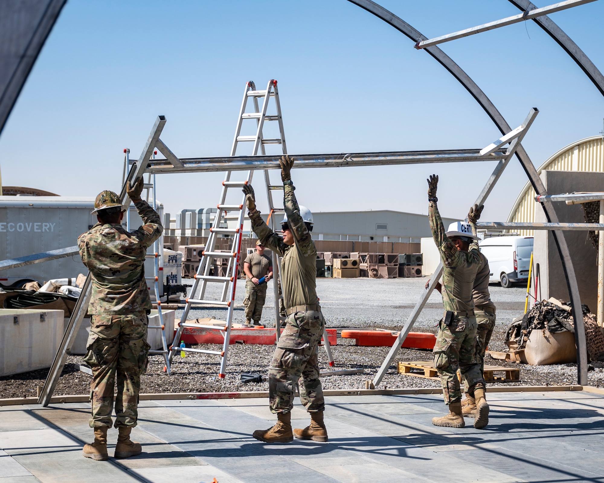 U.S. Air Force service members from the 386th Expeditionary Civil Engineer Squadron Dirt Boyz, receive training on the construction of a medium-sized shelter (MSS) at Ali Al Salem Air Base, Kuwait, July 6, 2023.