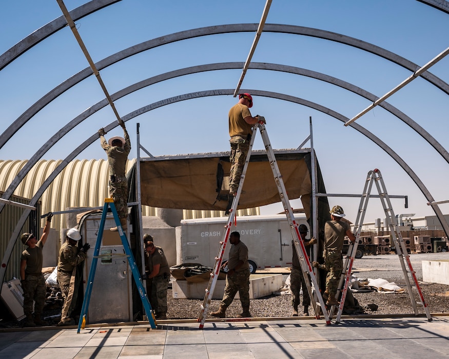 U.S. Air Force service members from the 386th Expeditionary Civil Engineer Squadron Dirt Boyz, receive training on the construction of a medium-sized shelter (MSS) at Ali Al Salem Air Base, Kuwait, July 6, 2023.