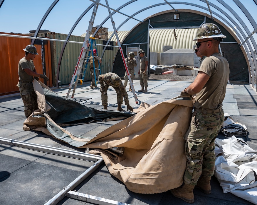 U.S. Air Force service members from the 386th Expeditionary Civil Engineer Squadron Dirt Boyz, receive training on the construction of a medium-sized shelter (MSS) at Ali Al Salem Air Base, Kuwait, July 6, 2023.