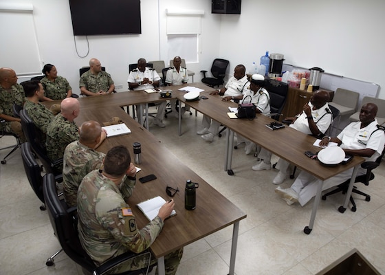 Sailors from two nations sit at tables