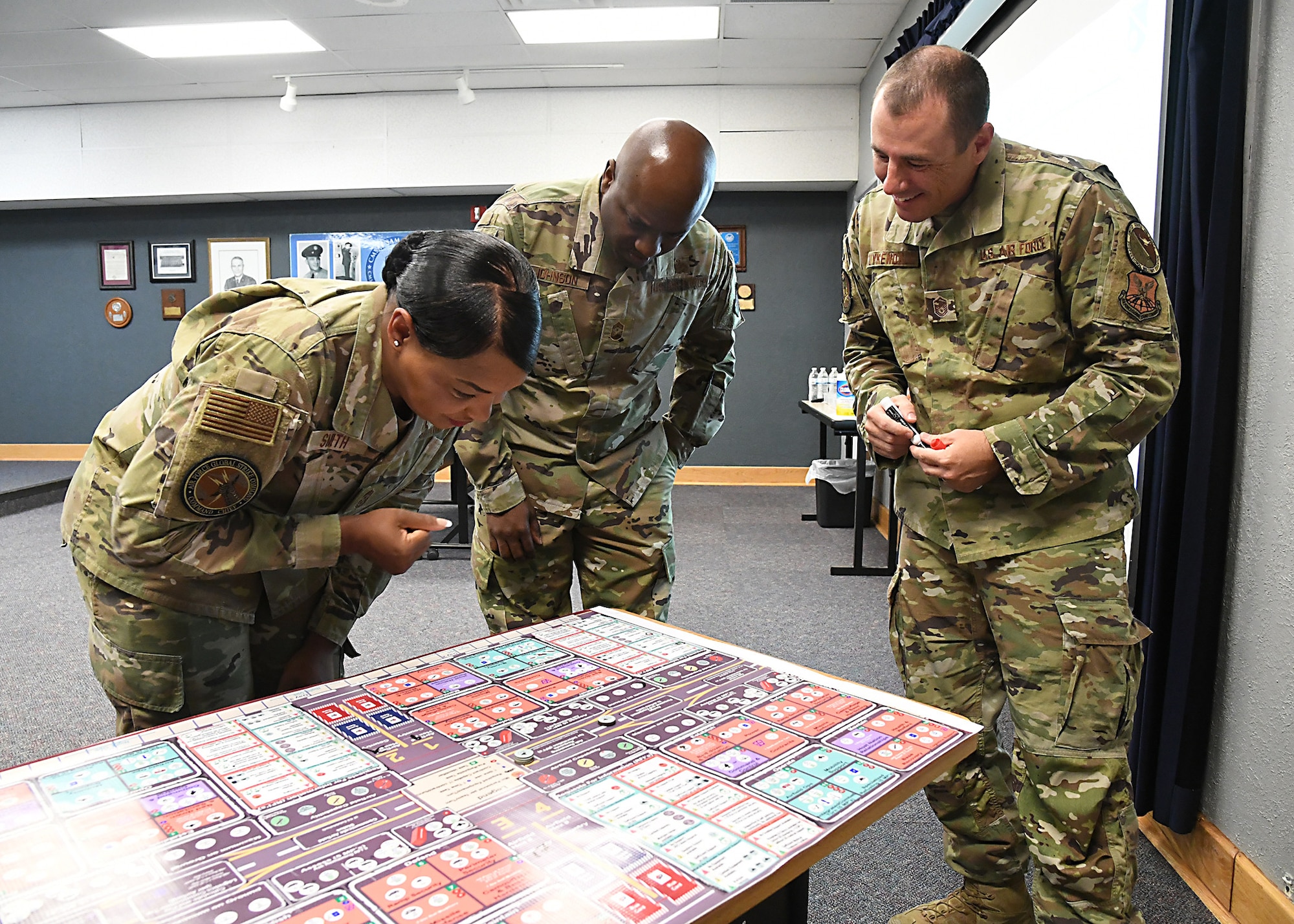 A woman views a board game.