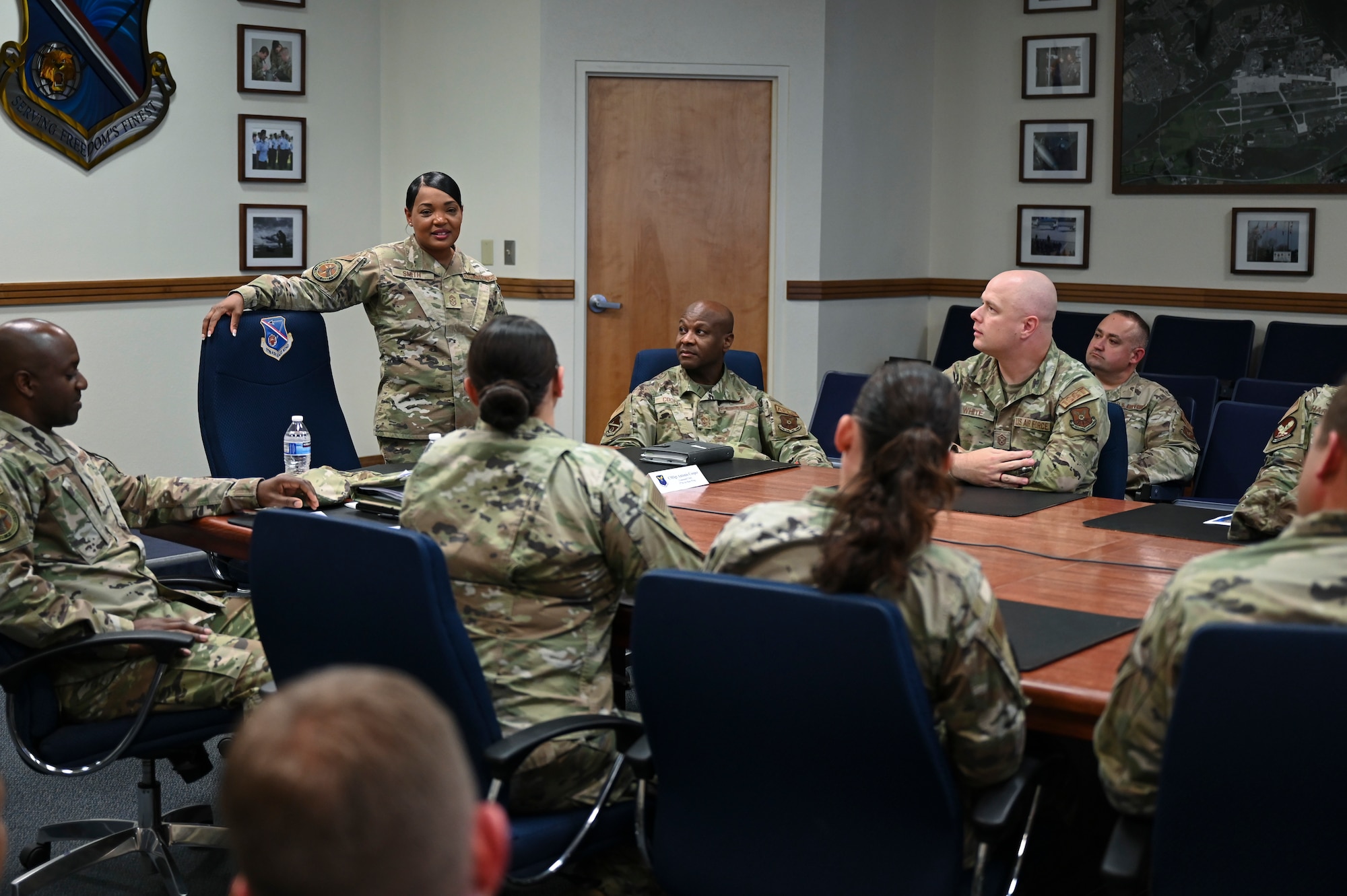 A woman speaks to a group of people.