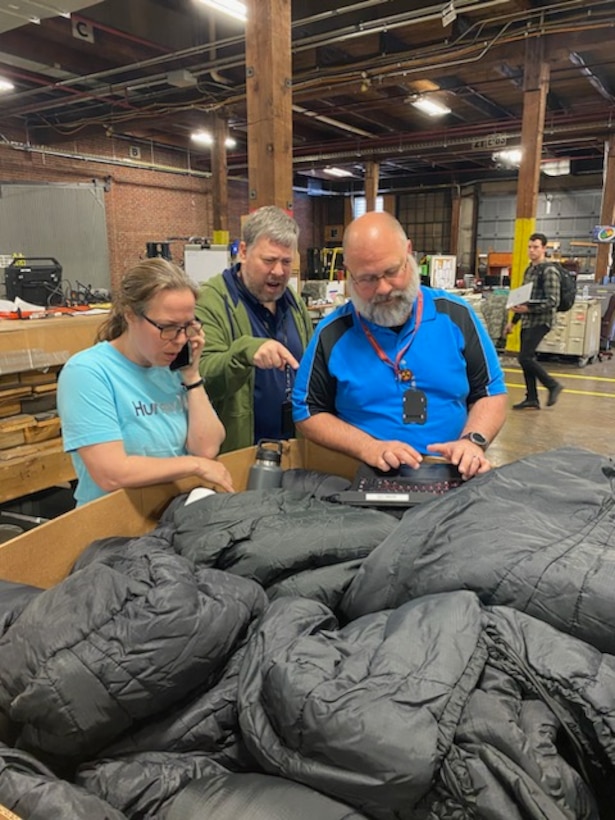 people work in warehouse on computers