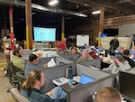 people work in warehouse on computers