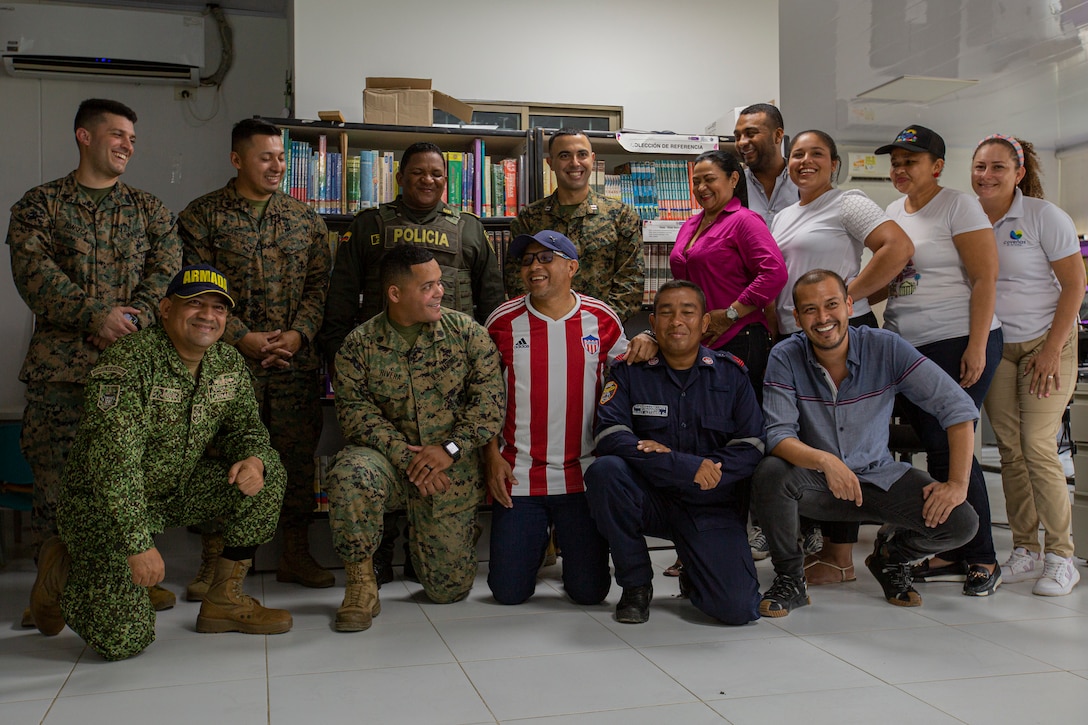 U.S. Marines with 4th Civil Affairs Group, Force Headquarters Group, in support of Special Purpose Marine Air-Ground Task Force UNITAS LXIV, pose for a photo with Rafael Ospina Toscano, mayor of Coveñas, along with other civilian leaders in Coveñas, Colombia, July 11, 2023. By meeting with local leaders, Marines forge bonds for the long-term advancement of regional security, maintaining favorable partnerships that deter aggression and supporting the stability that generates economic growth. UNITAS focuses on strengthening existing regional partnerships and encouraging the establishment of new relationships through the exchange of maritime mission-focused knowledge and expertise. (U.S. Marine Corps photo by LCpl. Samuel Qin)