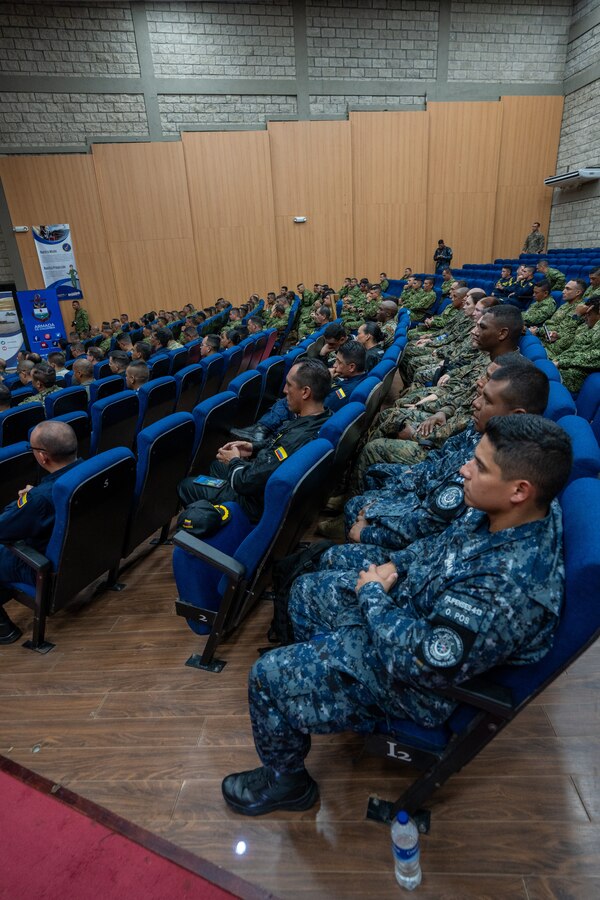 U.S. Marines and Sailors from Combat Logistics Battalion 8, Combat Logistics Regiment 2, 2nd Marine Logistics Group, in support of Special Purpose Marine Air-Ground Task Force UNITAS LXIV, sit alongside members of 8 different foreign nations during the closing ceremony of exercise SOLIDAREX, aboard Escuela de Formación de Infantería Marina Coveñas in Coveñas, Colombia, July 10, 2023. Twelve ships from eight countries participated in the humanitarian assistance exercise designed to train a multinational task force to respond to large-scale emergencies. This was the largest exercise of this kind in the Caribbean. (U.S. Marine Corps photo by Sgt. Juan Carpanzano)
