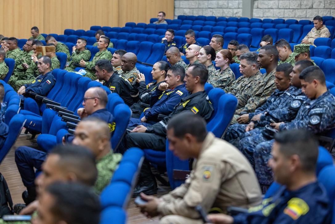U.S. Marines and Sailors from Combat Logistics Battalion 8, Combat Logistics Regiment 2, 2nd Marine Logistics Group, in support of Special Purpose Marine Air-Ground Task Force UNITAS LXIV, sit alongside members of 8 different foreign nations during the closing ceremony of exercise SOLIDAREX, aboard Escuela de Formación de Infantería Marina Coveñas in Coveñas, Colombia, July 10, 2023. Twelve ships from eight countries participated in the humanitarian assistance exercise designed to train a multinational task force to respond to large-scale emergencies. This was the largest exercise of this kind in the Caribbean. (U.S. Marine Corps photo by Sgt. Juan Carpanzano)