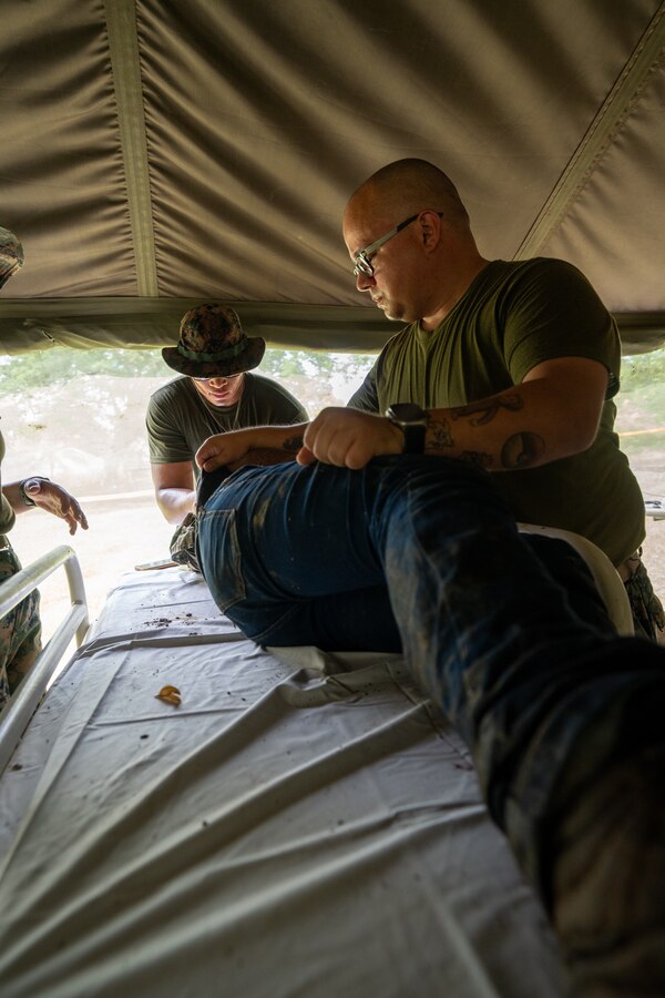 U.S. Navy Hospital Corpsman 2nd class Elvis Alamo, with Combat Logistics Battalion 8, Combat Logistics Regiment 27, 2nd Marine Logistics Group, in support of Special Purpose Marine Air-Ground Task Force UNITAS LXIV, provides medical care for a simulated casualty during Multinational Operation Solidarex 2023 aboard Escuela de Formación de Infantería Marina Coveñas in Coveñas, Colombia, July 9, 2023. Twelve ships from eight countries participated in the humanitarian assistance exercise designed to train a multinational task force to respond to large-scale emergencies. This was the largest exercise of this kind in the Caribbean. (U.S. Marine Corps photo by Sgt. Juan Carpanzano)