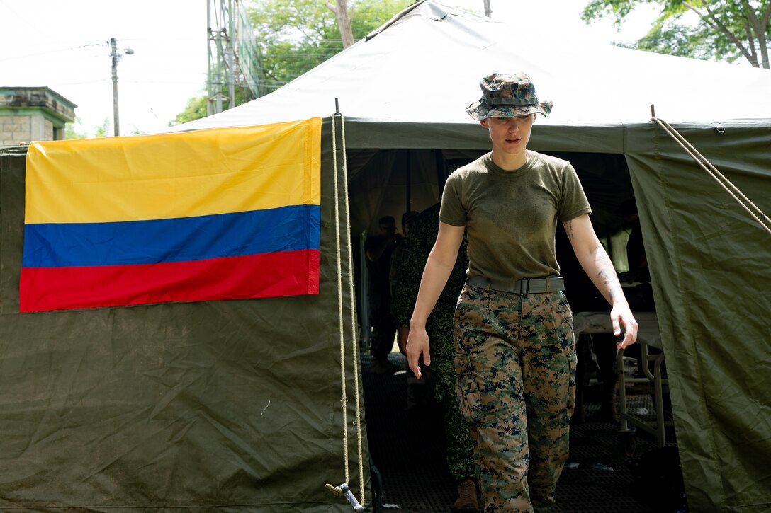 U.S. Navy LT. Amanda George, with Combat Logistics Battalion 8, Combat Logistics Regiment 27, 2nd Marine Logistics Group in support of Special Purpose Marine Air-Ground Task Force UNITAS LXIV, exits a medical tent during Multinational Operation Solidarex 2023 aboard Escuela de Formación de Infantería Marina Coveñas in Coveñas, Colombia, July 9, 2023. Twelve ships from eight countries participated in the humanitarian assistance exercise designed to train a multinational task force to respond to large-scale emergencies. This was the largest exercise of this kind in the Caribbean. (U.S. Marine Corps photo by Sgt. Juan Carpanzano)