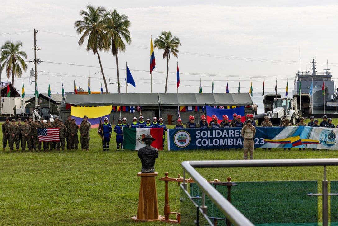 U.S. Navy Sailors from Combat Logistics Battalion 8, Combat Logistics Regiment 27, 2nd Marine Logistics Group, in support of Special Purpose Marine Air-Ground Task Force UNITAS LXIV, pose alongside members of 8 different foreign nations for a group photo during the opening ceremony of exercise SOLIDAREX, aboard Escuela de Formación de Infantería Marina Coveñas in Coveñas, Colombia, July 9, 2023. Twelve ships from eight countries participated in the humanitarian assistance exercise designed to train a multinational task force to respond to large-scale emergencies. This was the largest exercise of this kind in the Caribbean. (U.S. Marine Corps photo by Sgt. Juan Carpanzano)