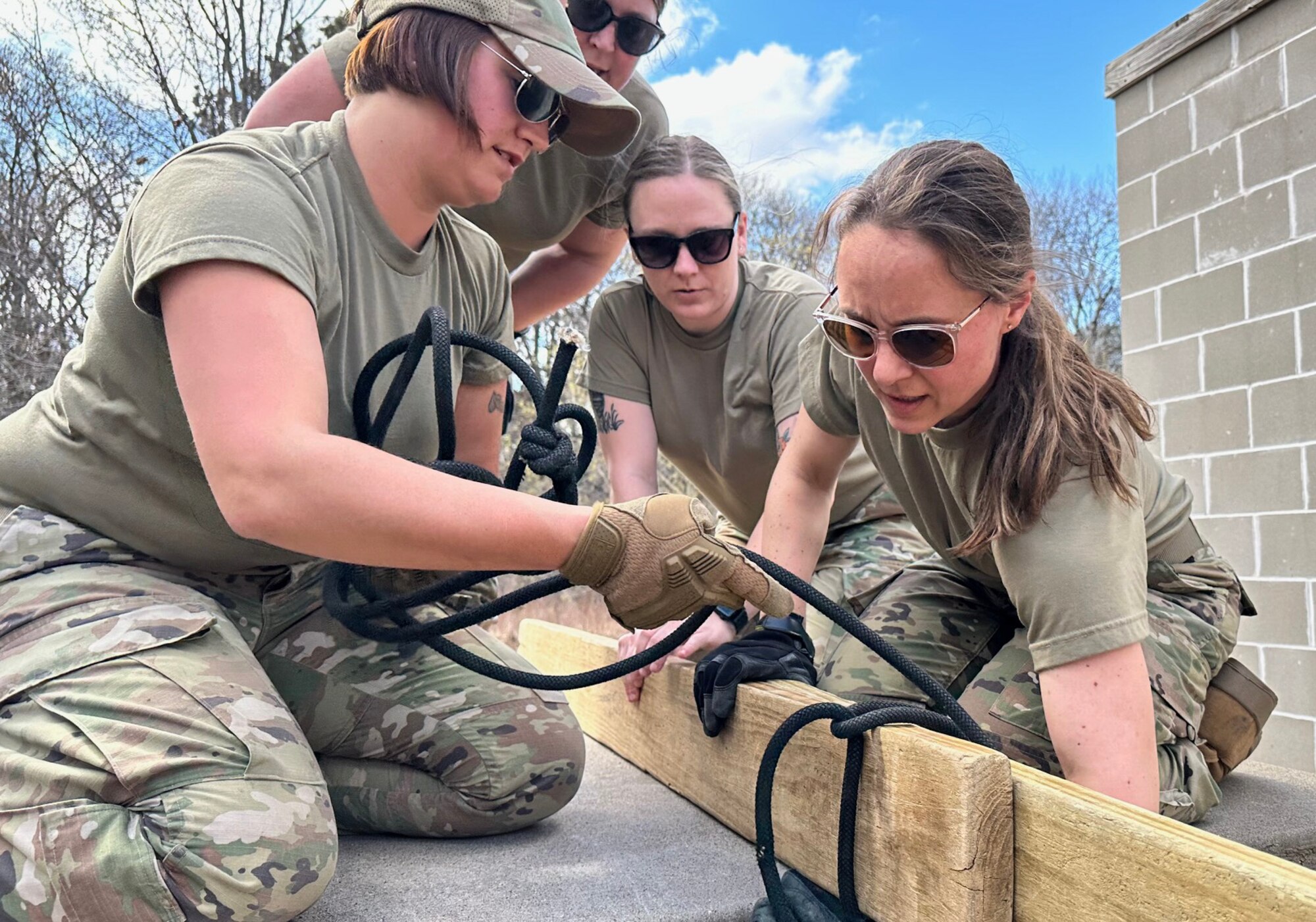 U.S. Air Force Airmen from the 133rd Force Support Squadron tie a rope around boards at Camp Ripley, Little Falls, Minn., May 6, 2023.