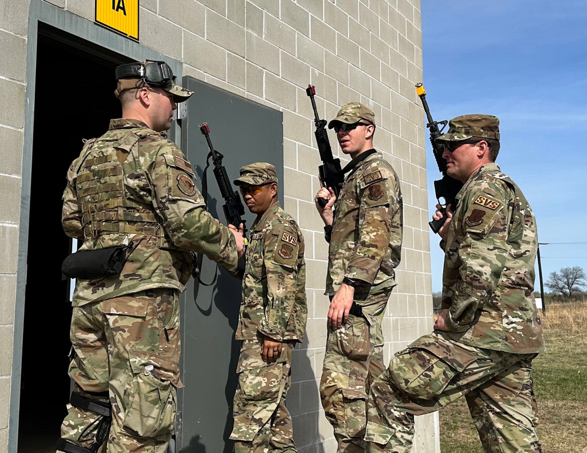 U.S. Air Force Staff Sgt. Jayson Camacho, Staff Sgt. Andrew Bosquez, and Senior Master Sgt. Joseph Sabin, 133rd Force Support Squdron, received final instructions from a security forces member before conducting building clearing procedures at Camp Ripley, Little Falls, Minn., May 6, 2023.