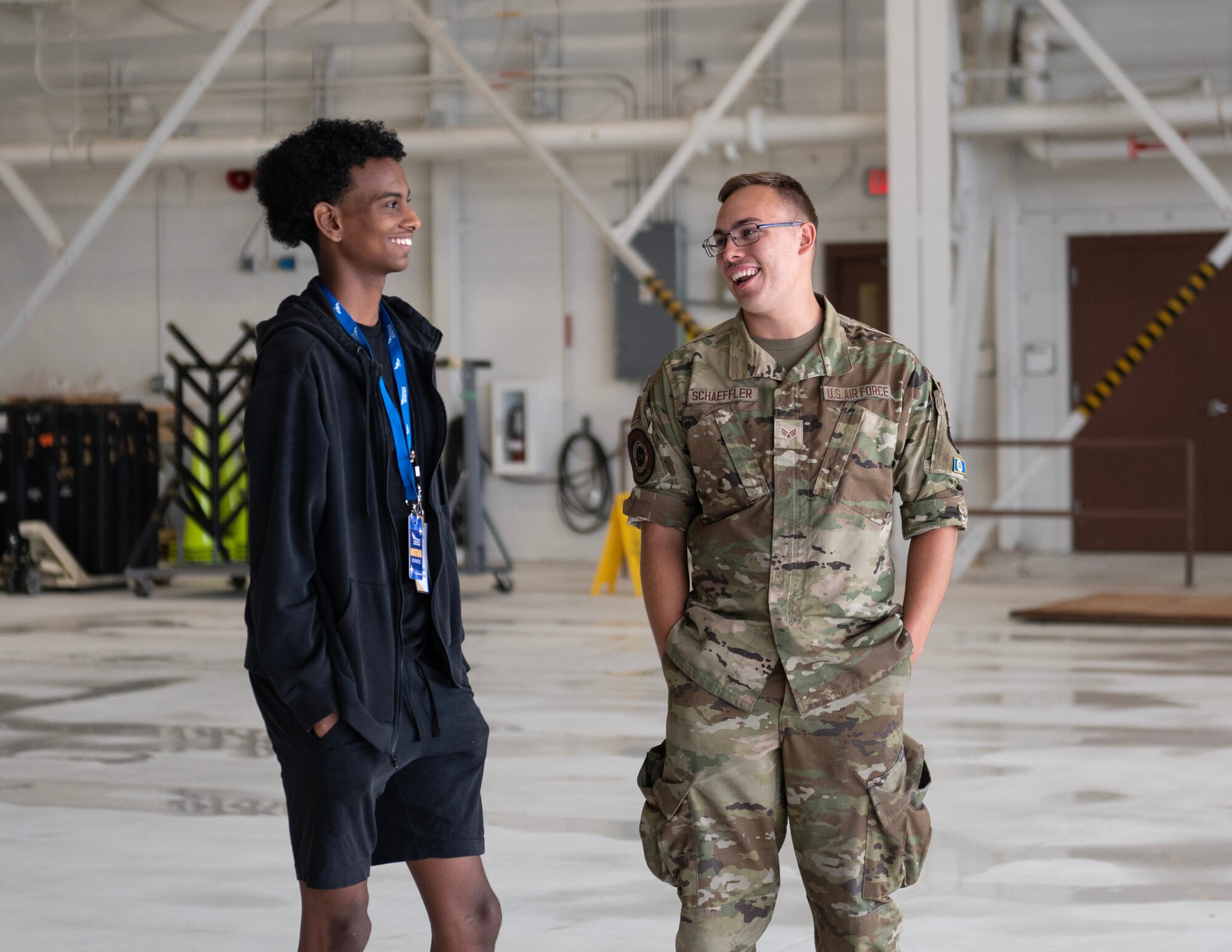 U.S. Air Force Senior Airman Kyle Schaeffler, 133rd Aircraft Maintenance Squadron, talks to a Minnesota Aviation Career Education Camp student in St. Paul, Minn., June 15, 2023.